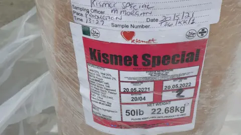 Swansea Trading Standards Pink kebab paste in the shape of a long donor covered in cling film with an ingredients label on it