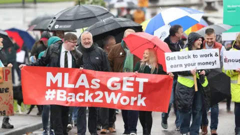 PA Media Demonstrators call for the Northern Ireland Assembly to sit again