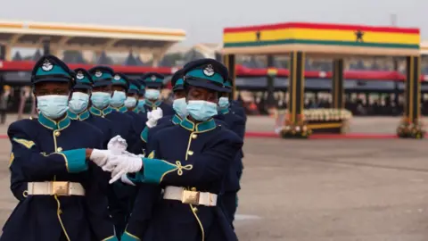 Getty Images Military officials march close to former Ghana President Jerry John Rawlings' casket during the final Funeral Rites in Accra, Ghana, on January 27, 2021.