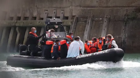 PA Media Migrants being brought to Dover