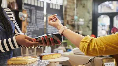 Getty Images Person paying for items