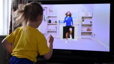 Getty Images Child follows Joe Wicks' PE session