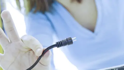 Getty Images Woman with an electric cable (file pic)