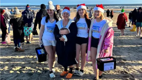 Clair Todd (second left) on the beach with her daughters Aimee, Chloe and Josie