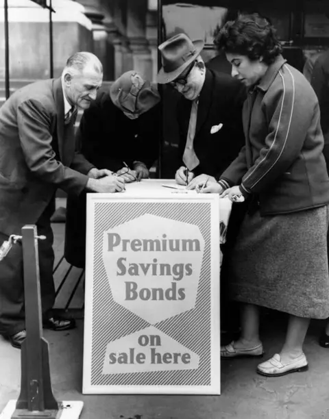 Getty Images Customers signing up for premium bonds in 1956