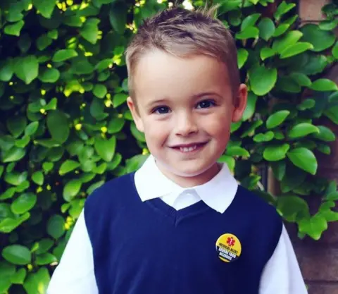 Lucy Patterson  Jack Patterson wearing a badge which lets others know he has severe food allergies