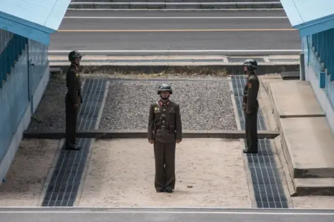 AFP/Getty Images n a photo taken on 2 June 2017, Korean People's Army (KAPPA) soldiers stand guard before the military demarcation line separating North and South Korea at the Joint Security Area (JSA) near Kaesong on the North Korean side of the border