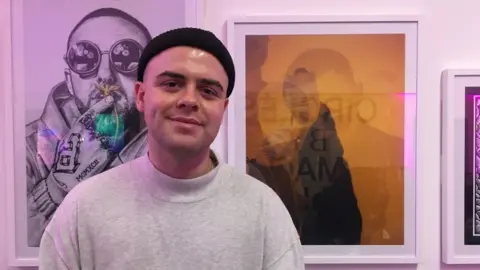 Henry Dean with one of his photos of Mac