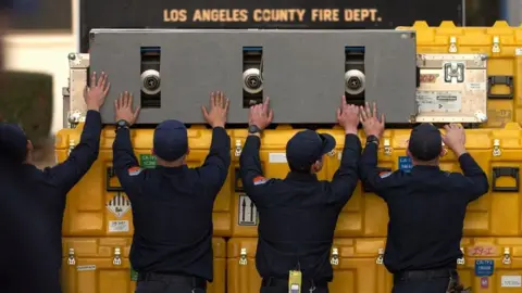 Reuters Four US firefighters pack supplies to go to Turkey