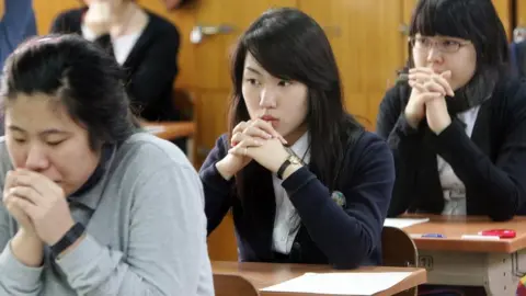 Getty Images Students prepare themselves to begin eight hours of back to back exams