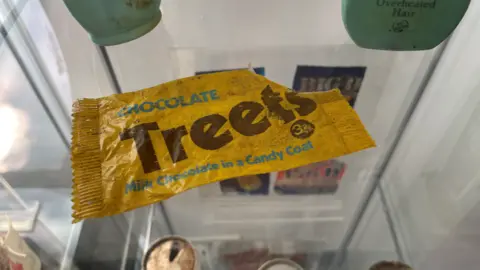 Mike Liggins/BBC An old yellow sweet bag.