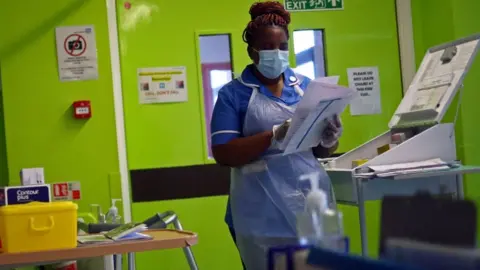Getty Images A nurse wears a face mask in Blackburn in May