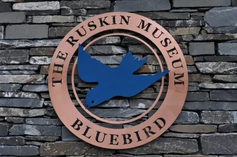 Tony Stuchbury Ruskin Museum's Bluebird logo