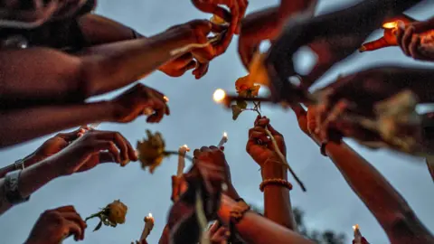 Reuters People holding up candles and roses in Goma, DR Congo - Tuesday 9 May 2023