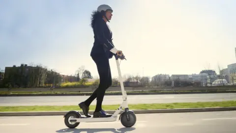 Getty Images Woman riding an e-scooter