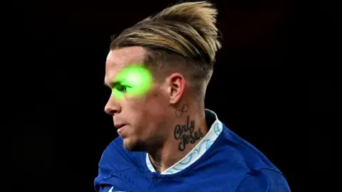 Getty Images A green laser is shone at Chelsea's Mykhailo Mudryk during a Premier League match against Arsenal in May