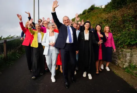  Ben Birchall / PA Media Liberal Democrat leader Ed Davey (centre) arrives with MP Daisy Cooper (front left), MP Layla Moran (front right) and parliamentary candidates for the Liberal Democrat conference at the Bournemouth Conference Centre