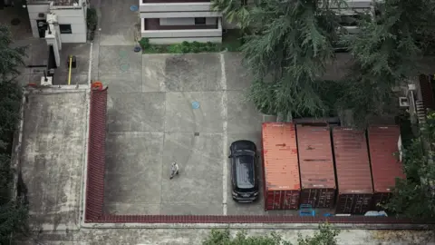 Getty Images A man enters the US Consulate General in Chengdu after China announced it was revoking the license of the US Consulate General in Chengdu on 24 July 2020