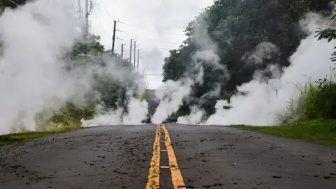 AFP Steam rises from a fissure on a road in Leilani Estates subdivision on Hawaii"s Big Island on May 4, 2018.