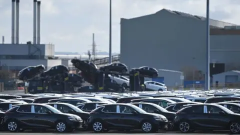 Getty Images Cars outside of a manufacturing plant.