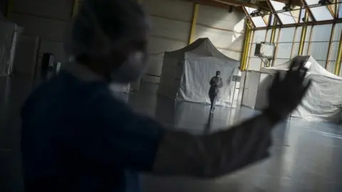 EPA A health care worker waits in an emergency centre in France