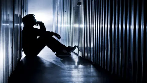 Getty Images Person sitting on the floor