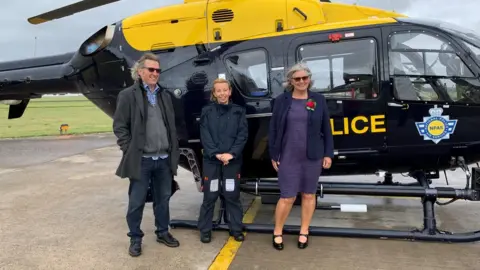 BBC Martin Hughes, Amy Rowlands and Linda Hughes outside a police helicopter