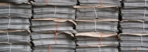 Getty Images piles of newspapers