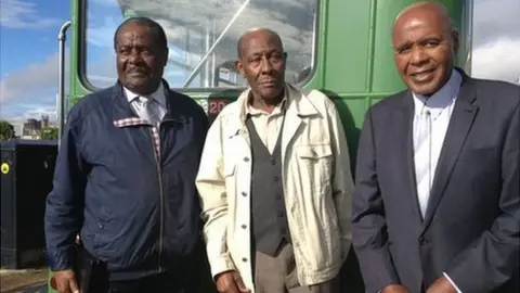 BBC Guy Bailey, Roy Hackett and Paul Stephenson in front of one of the original green buses - modern photo