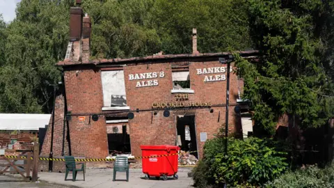 PA Media Crooked House pub before it was demolished 
