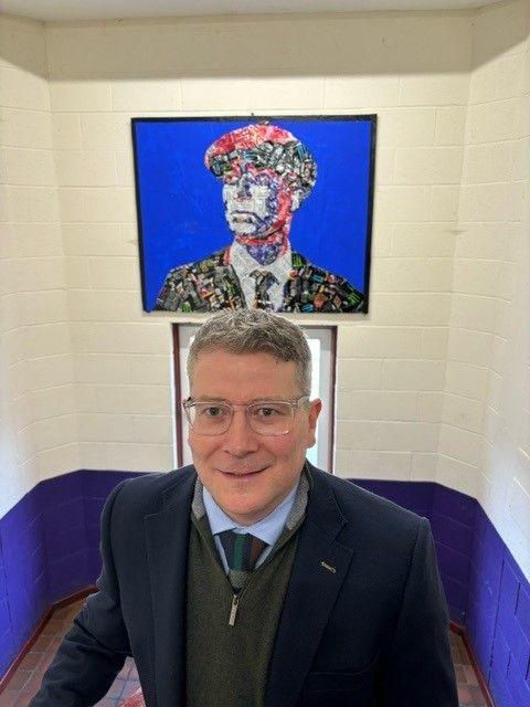 presentation college cork's principal david barry in front of cillian murphy portrait