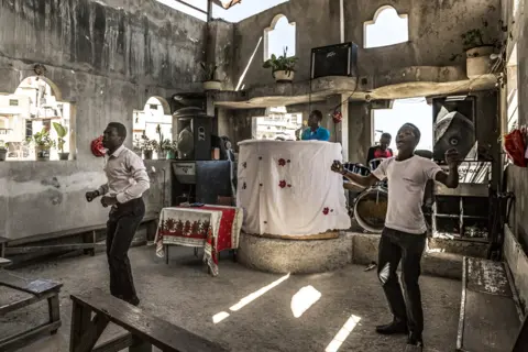 Tariq Zaidi Churchgoers pray inside Eglise Evangelique Baptiste church