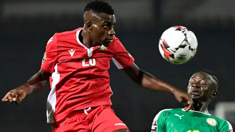 Kenya's midfielder Philemon Otieno (L) heads the ball next to Senegal's forward Sadio Mane during the 2019 Africa Cup of Nations (CAN) Group C football match between Kenya and Senegal at the 30 June Stadium in the Egyptian capital Cairo on July 1, 2019.