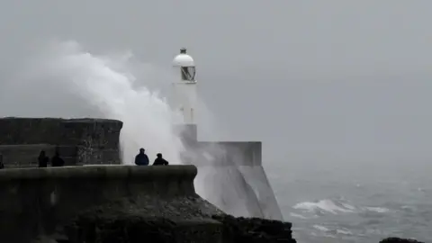 People watch the waves in Porthcawl