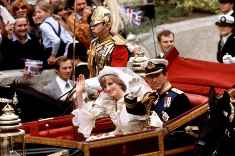 PA Prince of Wales and his bride, the Princess of Wales in an open-top carriage