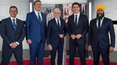 Pool via Reuters L-R: Yves-Francois Blanchet, Andrew Scheer, TVA network host Pierre Bruneau, Justin Trudeau, Jagmeet Singh