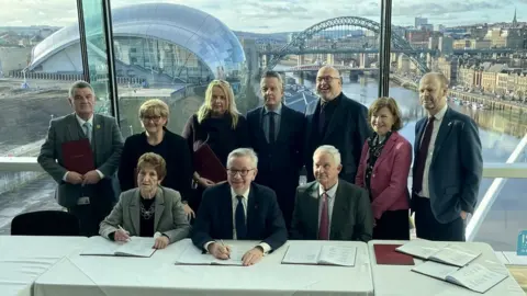 LDRS Michael Gove signing the deal in Gateshead