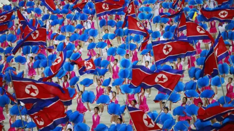 EPA Dancers waving North Korean flags