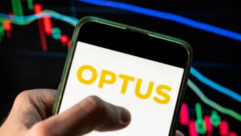 Getty Images Optus on a mobile phone