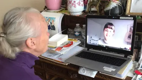 Supplied A French woman speaks to a student via video call