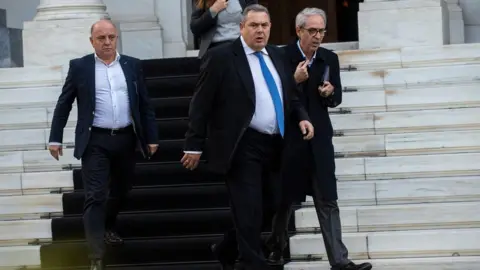 AFP Panos Kammenos (centre) leaves the Maximos Mansion after a meeting with Greek Prime Minister Alexis Tsipras in Athens on January 13, 2019
