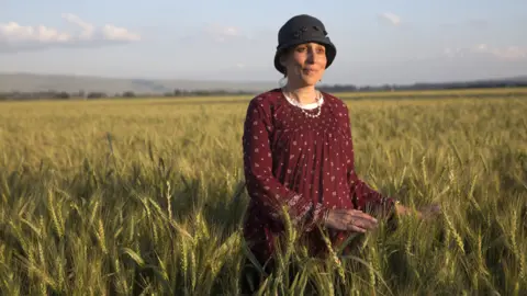 Heidi Levine Shani Taragin, 45, a women's health and Jewish law teacher, in a wheat field at the Hula Valley in the Upper Galilee in northern Israel during the Passover holiday. (Photo by Heidi Levine for The BBC).