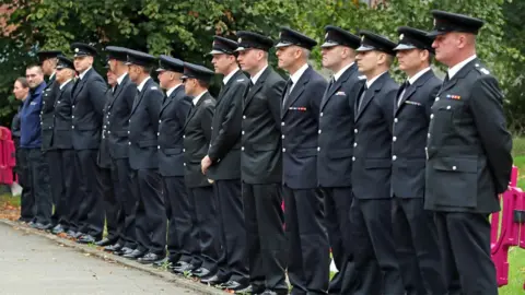 PA Emergency services personnel line up outside St Paul"s Church in Walkden