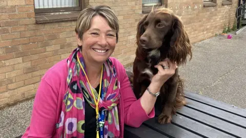 Luke Deal/BBC Rachel Bailey, head teacher at Abbotts Hall Primary School with therapy dog, Darcy