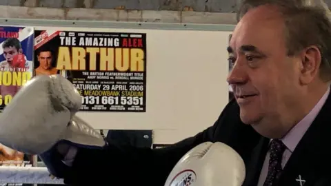 PA Media Alex Salmond dons gloves at a boxing gym