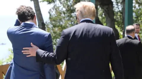 LUDOVIC MARIN/Getty Images Canadian Prime Minister Justin Trudeau (L) walks with US President Donald Trump during the official G7 Summit welcoming ceremony, 8 June, 2018 in La Malbaie, Canada