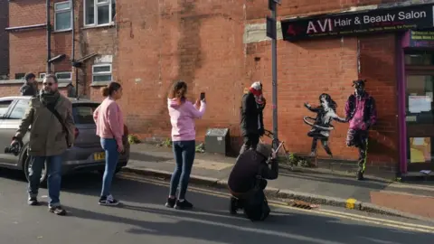 People visiting street art