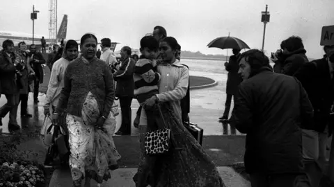 PA Media Asian immigrants from the Uganda arrive in Britain, circa 1972