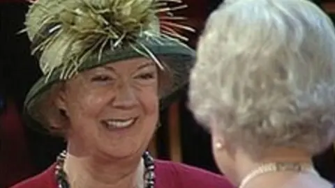 Dame Mary receiving her honour from the Wueen