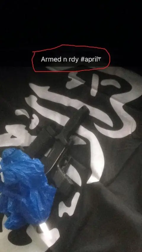 A weapon on a flag with the message "armed n rdy (sic)"